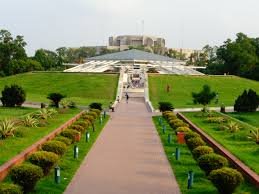Approach to the mausoleum along a formal walkway; Jatiya Sangsad Bhaban visible in the distance, Dhaka.
