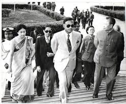 Ziaur Rahman and Khaleda Zia walking with officials during a formal overseas visit; black and white archival photo.